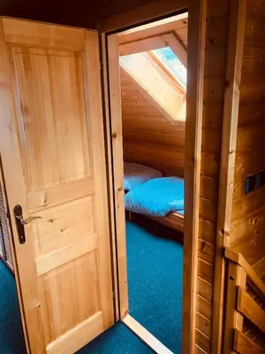 an open door to a room with a bed in it at Holiday Cottage Krishtan in Podčetrtek