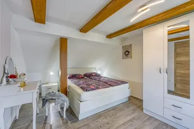 a small bedroom with a bed and a sink at Kolpa reka 