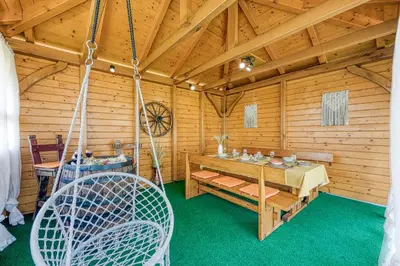 a room with a table and chairs in a cabin at Kolpa reka 