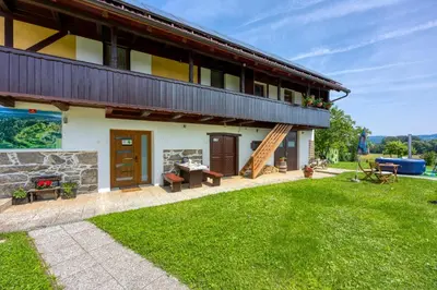 a house with a patio and a grass yard at Kolpa reka 
