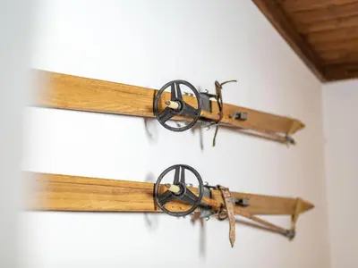 a group of wooden sticks hanging on a wall at The Green House in Mojstrana
