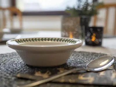 a bowl and a spoon sitting on a table at The Green House in Mojstrana