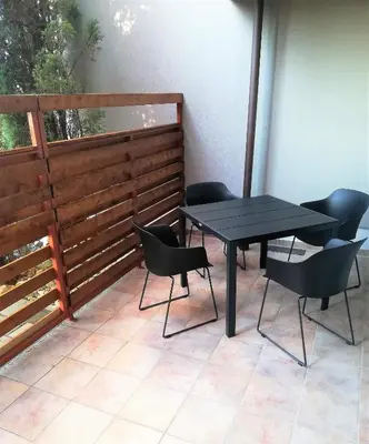 a black table and chairs on a patio at Apartment Leggero in Moravske Toplice