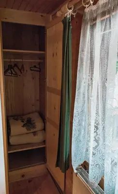 a room with a window with a curtain at PENZIJON URBANC in Lovrenc na Pohorju