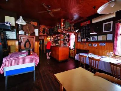 a person standing at a counter in a restaurant at PENZIJON URBANC in Lovrenc na Pohorju
