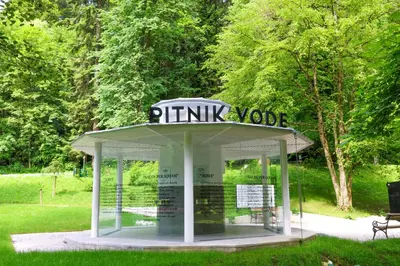 a kiosk with a sign on it in a park at Boutique Hotel Dobrna - Terme Dobrna in Dobrna