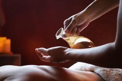 a person is washing their hands with a teapot at Boutique Hotel Dobrna - Terme Dobrna in Dobrna