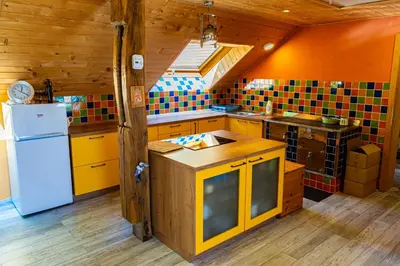 a kitchen with yellow cabinets and a white refrigerator at Apartment Vrhivšek in Frankolovo