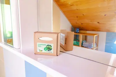 two boxes sitting on a shelf next to a window at Apartment Vrhivšek in Frankolovo