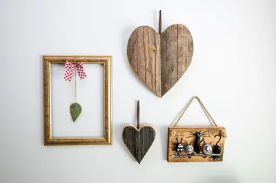 a wall with hearts and a picture and a picture frame at Apartmaji Rauter in Bohinj