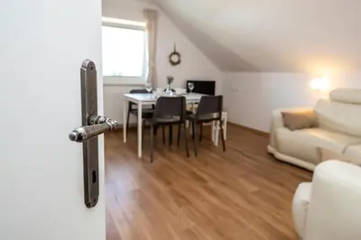 a living room with a table and a couch at Apartmaji Rauter in Bohinj