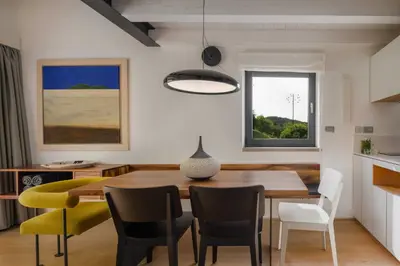 a kitchen and dining room with a table and chairs at Villa Artes with Free Hot Tub & Sauna in Branik