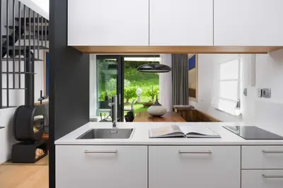 a kitchen with white cabinets and a sink at Villa Artes with Free Hot Tub & Sauna in Branik