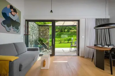 a living room with a couch and a table at Villa Artes with Free Hot Tub & Sauna in Branik