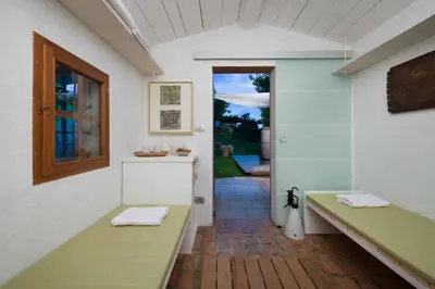 a hallway of a house with a bench and a window at Villa Artes with Free Hot Tub & Sauna in Branik