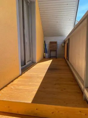 a hallway with a wooden floor and a window at Apartma Nina in Bohinj