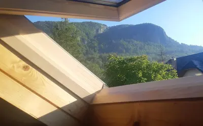a view of a mountain from a window in a house at Apartma Nina in Bohinj