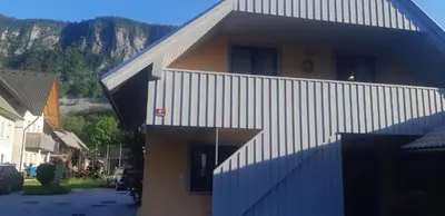a building with a staircase on the side of it at Apartma Nina in Bohinj