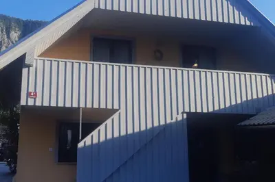 a building with a blue and white wall at Apartma Nina in Bohinj