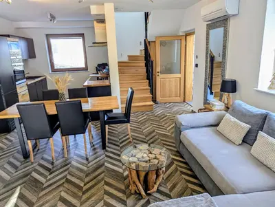 a living room with a couch and a table at MY TIME BLED Holiday House with sauna in Zgornje Gorje
