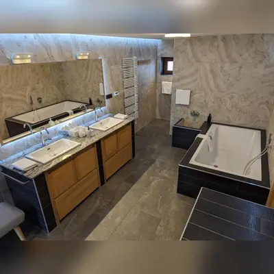 a bathroom with two sinks and a bath tub at MY TIME BLED Holiday House with sauna in Zgornje Gorje