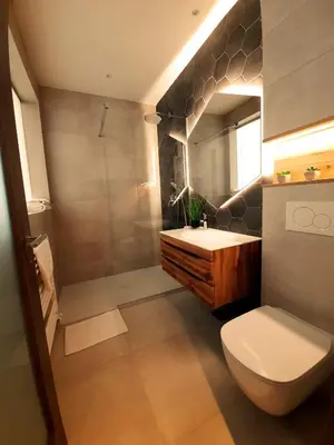 a bathroom with a white toilet and a sink at Petkovšek Rooms and Apartments in Ljubljana