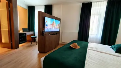 a hotel room with a bed with a hat on it at Petkovšek Rooms and Apartments in Ljubljana
