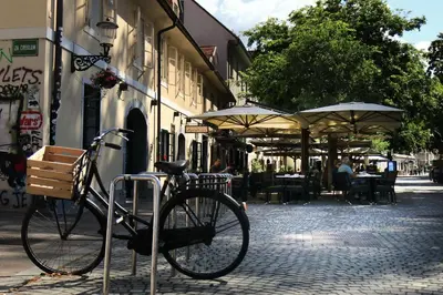 a bike parked on a street with umbrellas at Petkovšek Rooms and Apartments in Ljubljana