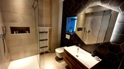 a bathroom with a shower and a toilet and a sink at Petkovšek Rooms and Apartments in Ljubljana