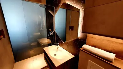 a bathroom with a sink and a mirror at Petkovšek Rooms and Apartments in Ljubljana