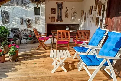 a group of chairs and a table in a patio at Charming blacksmith`s house @ Lake Bohinj in Bohinj
