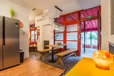 a kitchen and dining room with a table and a refrigerator at Apartma N'Poznam in Ljubljana