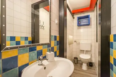 a bathroom with a sink and a toilet at Apartma N'Poznam in Ljubljana