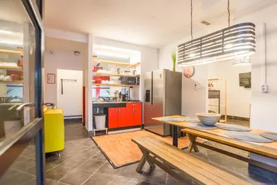a large kitchen with a wooden table and a counter at Apartma N'Poznam in Ljubljana