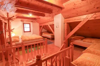 a room with three bunk beds in a log cabin at House Alpine Rose in Mojstrana