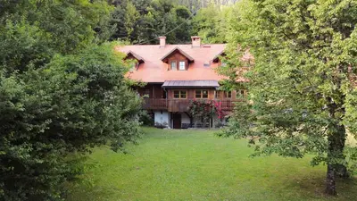 a large house in the middle of a yard at House Alpine Rose in Mojstrana