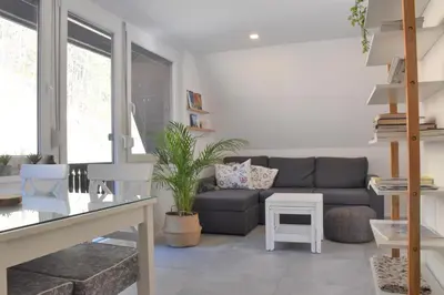a living room with a couch and a table at Our Forest House in Tržič