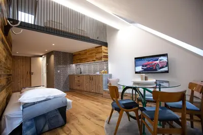 a bedroom with a bed and a table with chairs at Becycle Sustainable stay and travel in Maribor