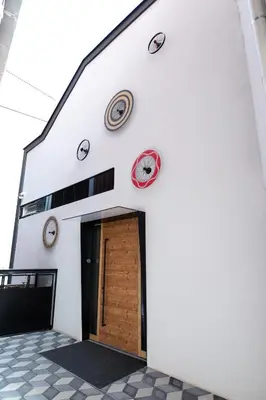 a white building with clocks on the side of it at Becycle Sustainable stay and travel in Maribor