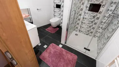a small bathroom with a shower and a toilet at Holiday house Zupanc in Bohinj