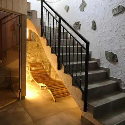 a staircase with a bench next to a brick wall at Holiday house Zupanc in Bohinj