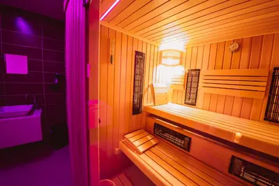 a small wooden sauna with a light in a room at Savna cimr in Mežica