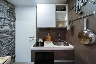 a kitchen with a sink and a white cabinet at Savna cimr in Mežica