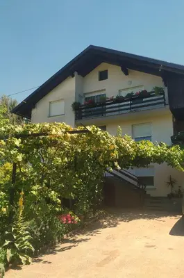 a building with flowers and plants in front of it at Eko kmetija Gerbec in Grahovo