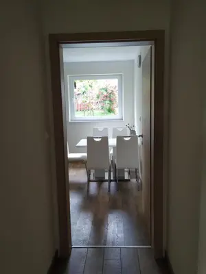 a dining room with a table and chairs and a window at Eko kmetija Gerbec in Grahovo