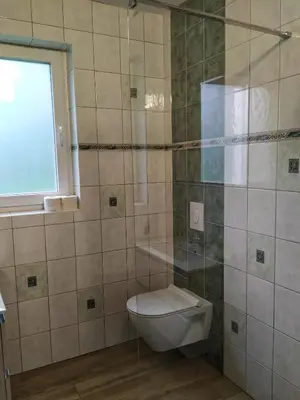 a bathroom with a toilet and a window at Eko kmetija Gerbec in Grahovo