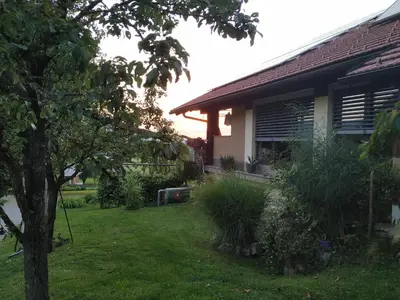 a yard next to a house with a tree at Eko kmetija Gerbec in Grahovo