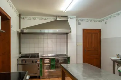 a kitchen with a stove and a stove top oven at House Donačka Gora in Rogatec