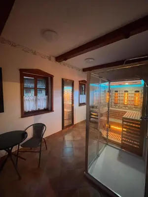 a room with a glass window and a table and chairs at House Donačka Gora in Rogatec