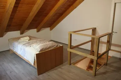 a bedroom with a bed and a book shelf at Apartments Jez in Slappe dʼIdria